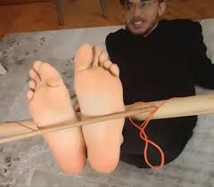 Tied guy bastinado- extreme falaka