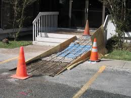 Hold the post while pouring in the concrete. Concrete Wheelchair Ramp Installation Parking Lot Repair Wheelchair Ramp Ramp Design Outdoor Ramp