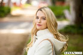 On a warm spring sunny day beautiful young girl with long blond hair in a white dress sitting on the beach, the lake on a bright sunny day 4505494 Blonde Vixen Com Looking Over Shoulder Smiling Kenna James Coats Long Hair Pink Lipstick White Coat Face Looking At Viewer Glamour Women Women Model Wallpaper Mocah Hd Wallpapers