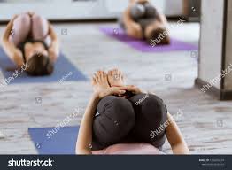Each class is designed to sustain the body as it allows you to build strength. Yoga Class Group Of People In Fitness Studio Meditation In Apanasana Or Wind Pose Healthy Lifestyle And Wellness Recreation Fitness Studio Yoga Class Yoga
