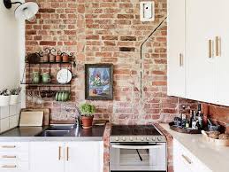 Rustic Exposed Brick Wall Accents In The Minimalist Kitchen Design Featuring Large White Cabinetry An Brick Wall Kitchen Exposed Brick Kitchen Brick Wall Decor