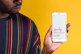 Download Man Holding An Iphone Mockup Against A Yellow Wall Iphone Mockup Iphone Promotional Image