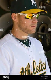 Oakland Athletics first baseman Daric Barton (10) reaches for the throw as  Texas Rangers' Robinson Chirinos (61) makes it safely to first