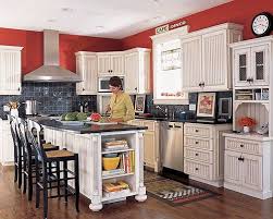 The cabinets are painted in a light cream color and topped with matching cream granite. Dark Counters And Backsplash With Red Paint Diy Kitchen Remodel Kitchen Decor New Kitchen Cabinets