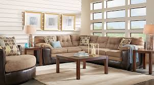 In this living room, the furniture is paired with decorative wallpaper in an abstract blue pattern. Beige Brown Blue Living Room Furniture Decorating Ideas