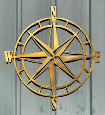Crafted from wrought iron, this alluring design strikes an open circle frame in a rustic painted finish. Nautical Compass Rose Metal Wall Art Compass Wall Art Etsy Wall Art Metal Wall Art
