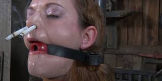 Ruined red-haired hussy smokes cigarettes with nose holes