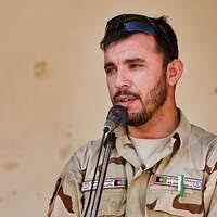 Combat Medic, Spc. Eric Hegge helps to carry lumber