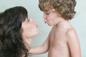 Hispanic mother and son blowing kisses - Stock Photo - Dissolve