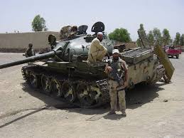 File:Layne Morris poses in front of a Soviet era tank in Afghanistan.jpg
