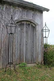 It's crafted from durable metal and enhanced with scrolling details. Metal Candle Sconces Wrought Iron Garden Lanterns