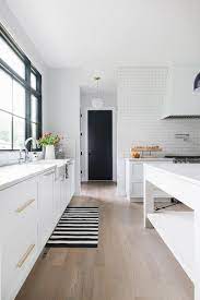 My rafter house dining rooms wide planked hardwood floors. White Shaker Kitchen With Light Gray Wood Floors Transitional Kitchen