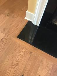 Engineered Hardwood Trimmed Out Around Granite Fireplace Hearth Impressions Hardwood Denali In Wheat Color Fireplace Hearth Granite Fireplace Granite Hearth