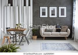 Greys, creamy and pink work perfect for a glam girlish space. Multifunctional Monochromatic Living Room With Carpet Dining Table And Sofa Against Dark Wall With Posters Canstock