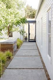 Walkway In Outdoor Courtyard Of Modern Design Home By Trinettereed Stocksy United Outdoor Landscape Design Landscaping Costs Walkway Landscaping