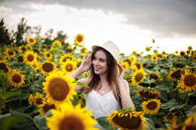 Women, smiling, flowers hd desktop background was posted. Wallpaper Smiling Sunflowers Hat Plants Women Outdoors Yellow Flowers 2560x1707 Wallpapermaniac 1474823 Hd Wallpapers Wallhere