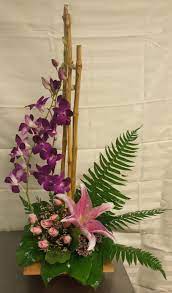Breathtaking Contemporary Arrangement Of Dendrobium Orchids Spray Roses And A Beautiful Pink Lily Orchid Arrangements Dendrobium Orchids Flower Arrangements