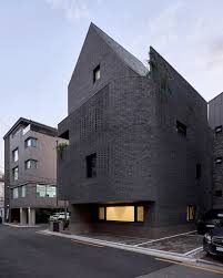 a round architects sculpts seoul office building with rusticated stone