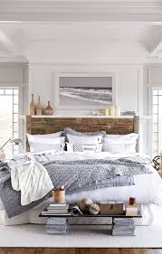 This farmhouse master bedroom pulls it off by pairing a sliding barn door and weathered bench with sleeker furnishings, like a midcentury modern pendant light. Remodelaholic Modern Coastal Bedroom Decor Tips Inspiration
