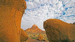 The highest outcrop rises about 1784 meters (5857 feet) above sea level. Climbing Spitzkoppe Granite Mountain In Namibia