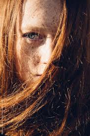close up of a girl s blue eye with her ginger hair covering half her face by maresa smith trockene haare haare fettige haare