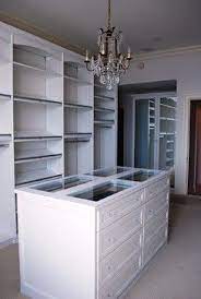 It allows the owner to store small items in drawers within the closet, reducing the need for. Master Dressing Room With Island Shoe Fences Rosettes Traditional Closet Baltimore By California Closets Closet Island Luxury Closet Closet Remodel