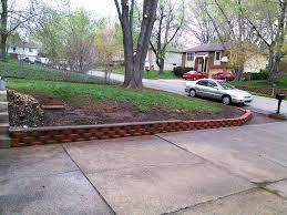 Creating A Low Profile Retaining Wall Against The Edge Of Driveway Looks Great Retaining Wall Design Retaining Wall Design