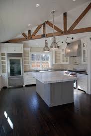 We love kitchens with wooden beams because they look dreamy and just amazing, they a rustic english country kitchen in light grey, white textural walls, wooden beams on the ceiling for a cozy feel. Exposed Wood Beams Transitional Kitchen Christine Curry Design