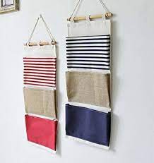 34 Cool Things That Belong On Your Empty Walls Wall Hanging Storage Fabric Storage Hanging Fabric