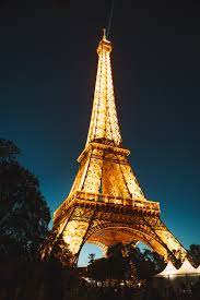Distant lights are dim at night, and the city of paris is no exception. Eiffel Tower At Night Photo Free Image On Unsplash