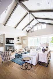 Transitional Living Room Boasts Vaulted Ceilings With Wood Beams Vaulted Ceiling Living Room Ceiling Beams Living Room Beams Living Room