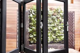 unfold a world of greenery from your home with our classic black bi fold windows stegbar windows bi fold ti windows aluminium windows outdoor living space