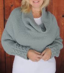 A sleeve that ends in a shawl, worked in reversible cables with two very different sides and lined by checks, made to drape and pin together as you wish. Sleeved Poncho Knitting Patterns In The Loop Knitting