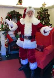 Santa claus near the fireplace and tree with gi. La S Top Best Places To See Santa In Los Angeles Momsla