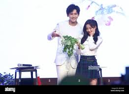 Chinese singer and actress Ju Jingyi, right, and actor Zhang Zhehan attend  a fan meeting to promote their new TV drama Legend of Yunxi in Beijing, C  Stock Photo - Alamy