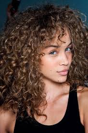 Messy And Voluminous Light Brunette Curly Hair With Darker Roots Highlights And Curly Bangs W Curly Hair Styles Dark Curly Hair Curly Hair Styles Naturally