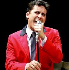 There is a comb, a nice outfit, and a pair of aviators. Hire John Lloyd Young For Your Event Celebrity Agent