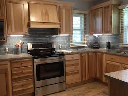 Hickory Cabinets And Range Hood With Smoky Blue Backsplash And Under Cabinet Lighting Hickory Cabinets Kitchen Backsplash Designs Small Kitchen Renovations