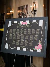 seating chart with guest names and table numbers on black