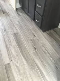 Gray is cool and should be a backdrop to colour as well as provide a balance of cool among warm wood tones. Flooring Ideas Apartment Bathroom Design Grey Wood Tile Wood Plank Tile