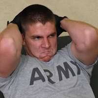 Professional wrestling champion and actor Bill Goldberg compares biceps  with Photographer's Mate Airman Kathleen Gorby during a tour of USS Ronald  Reagan (CVN 76)'s Photo Lab.