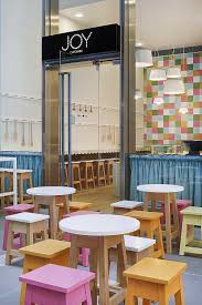 Interior Design For A Cupcake Shop With Pink Orange And White Table In Front Shop Cake Shop Design Store Design Interior Cupcake Shop Interior