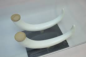 The oval glass tabletop is made from thick glass with a cut edge. Sold Price A Faux Elephant Tusk Coffee Table Base With Brass Elements And A Stair Stepped Marble Base And Glass Top Attributed To Maison Jansen Italy November 3 0117 5 30 Pm Est