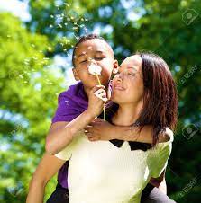 Close Up Portrait Of A Happy Single Mother With Son Blowing Dandelion Stock  Photo, Picture and Royalty Free Image. Image 28450371.