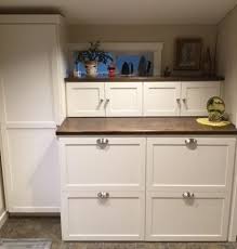 The washer and dryer in this kitchen sit just below the countertop, behind a set of cabinet drawers. Hidden Washer Dryer In The Mud Room Combs Painting
