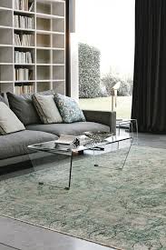 The curved profile of the glass offers a considered and unique design. Coffee Table In Curved Transparent Glass Idfdesign