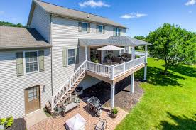 The first step in the process of erecting the hip roof is to get the ridge beam into place at the top of the roof. Covered Porch With Hip Roof In Harrisburg Pa Stump S Decks