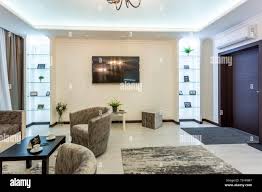 MINSK, BELARUS - January, 2019: luxure hall interior loft flat apartments  with tv sofa and armchairs Stock Photo - Alamy