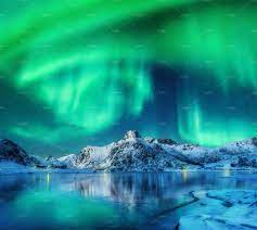 Aurora Borealis Over Snowy Mountains Aurora Borealis Northern Lights Aurora Sky Northern Lights Wallpaper