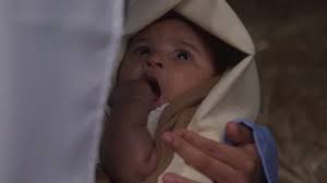 Baby Jesus Looking at Mary as She Rocks Him